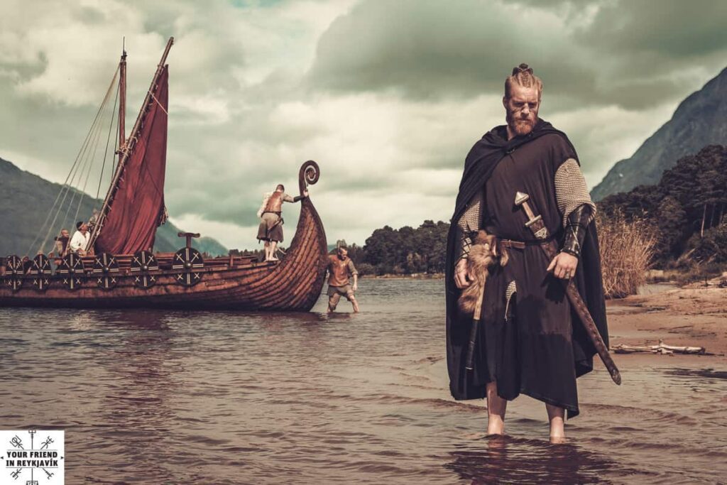 Viking warrior with sword standing on the seashore